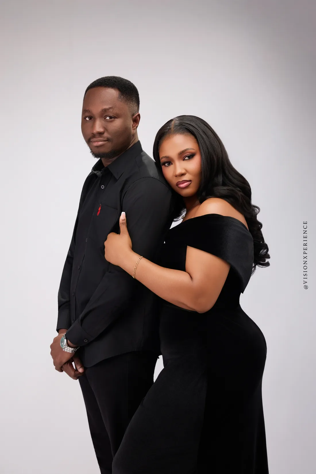 Herbert and Mariam in black, standing back to back