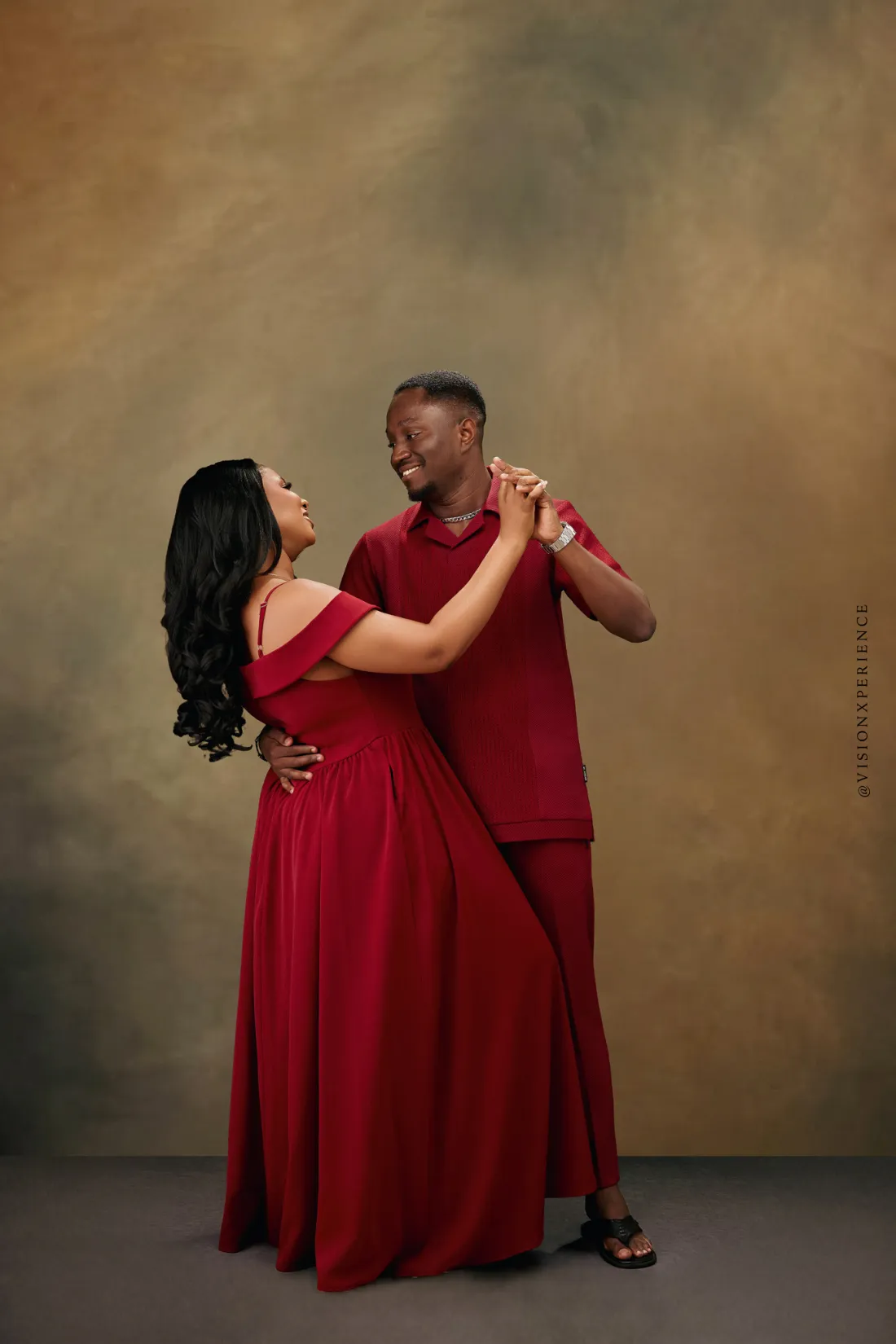 Herbert and Mariam in red, dancing and laughing together