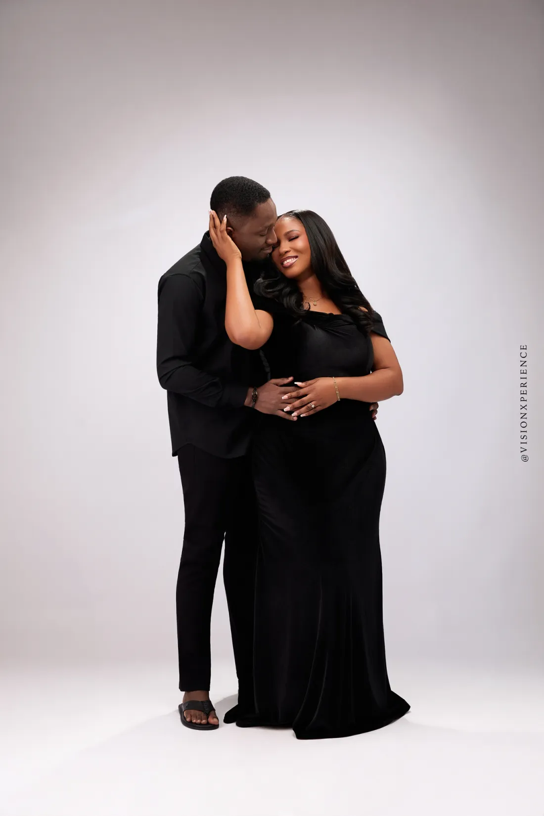 Herbert and Mariam in black, foreheads together, smiling